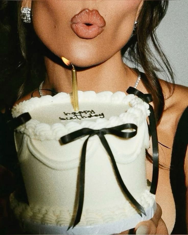 Woman holding a birthday cake at a party